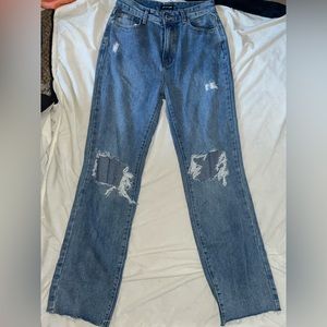 Ripped jeans, loose fitting.